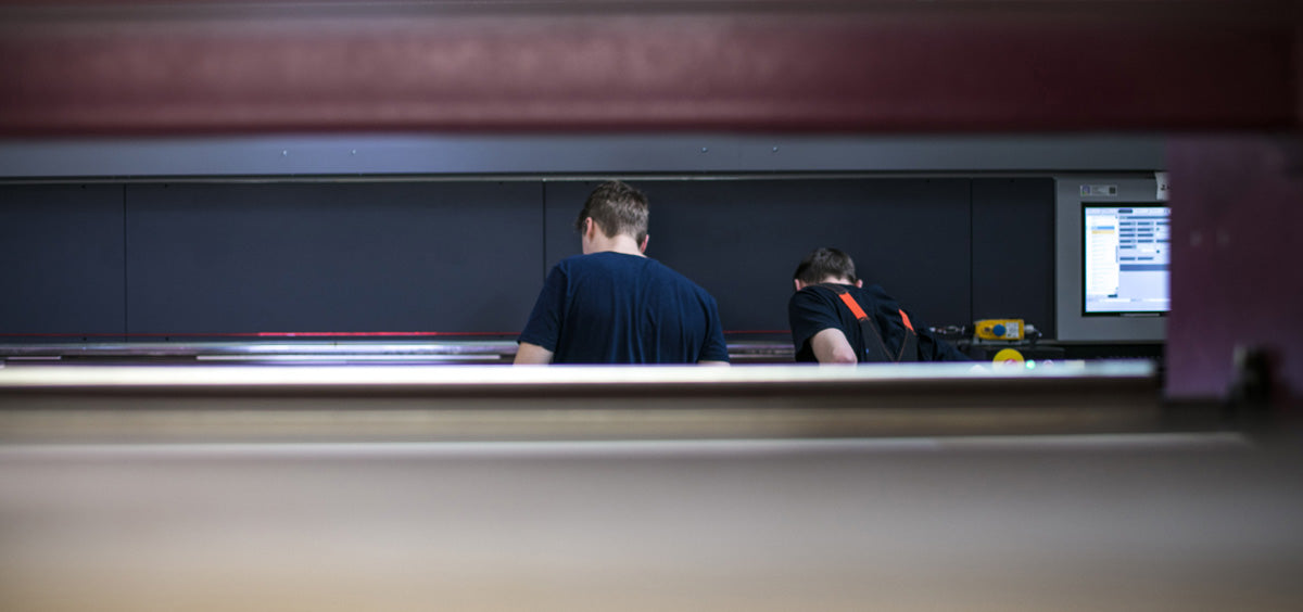 Nordsign production team working at a large-format UV printer